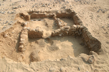 Trench 2 after excavation, showing two intercommunicating rooms of a building running north-south. Note that walls run through the east, south and west baulks. Facing east.